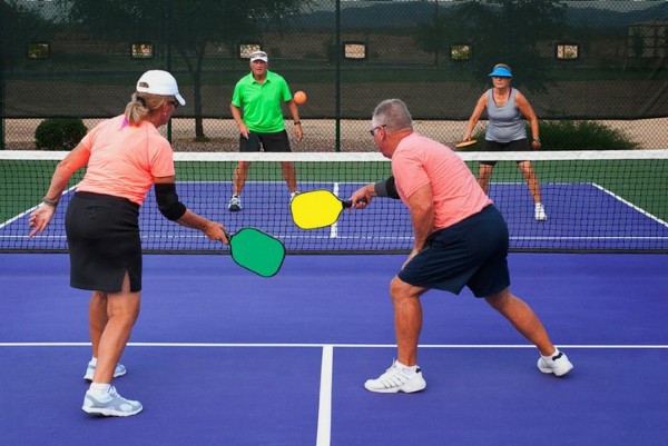 An older player with a traditional paddle looking skeptically at a neon paddle